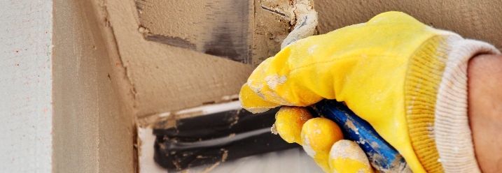 Person verputzt Fensterlaibung